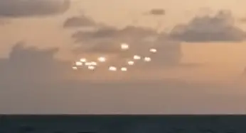 Several Glowing Objects Hanging Above the Horizon in a Lagoon Off the Coast of North Carolina